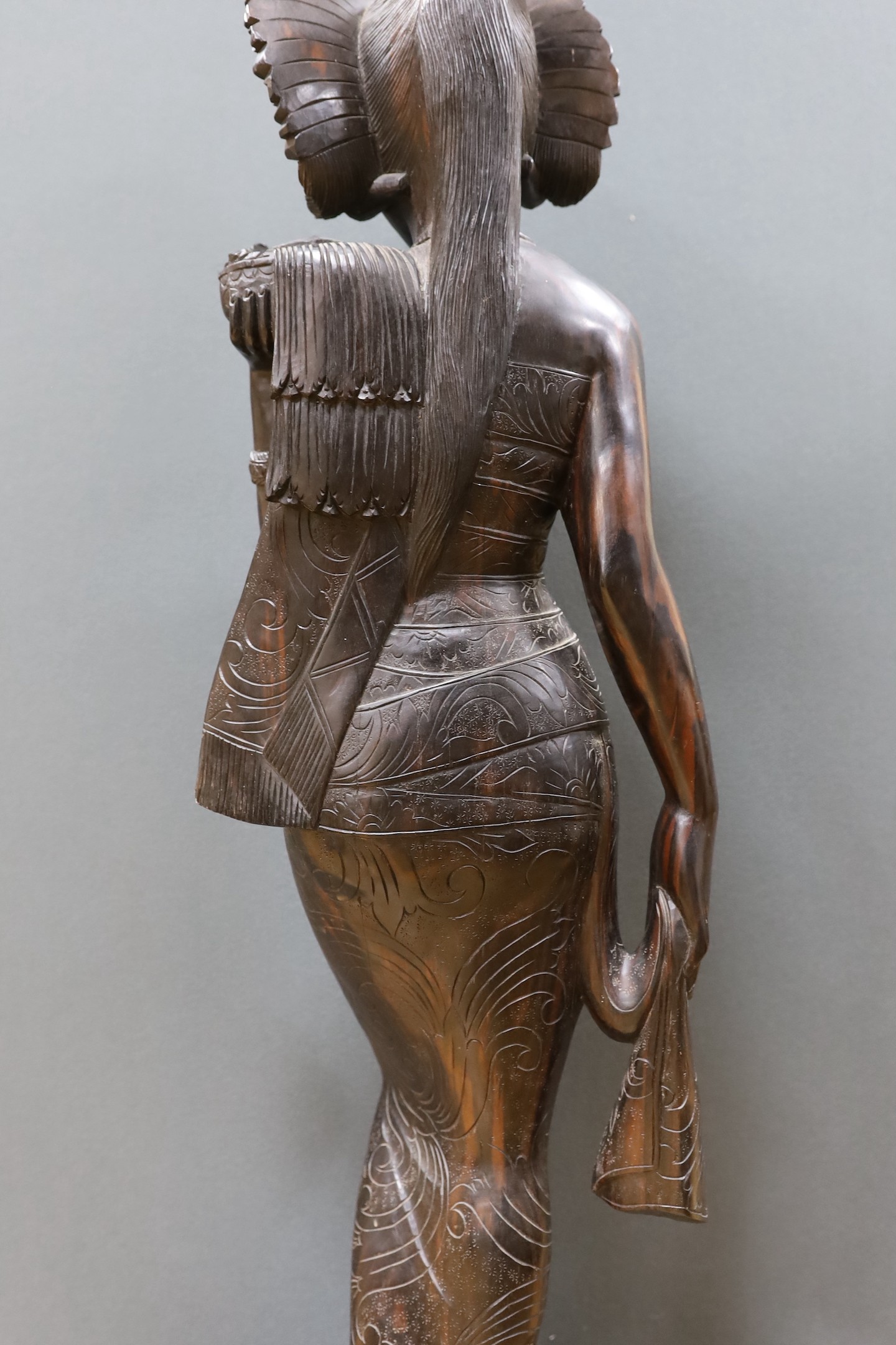 An unusually large and well-carved Balinese ebony figure of a standing young girl, early/mid 20th century. From a Bournemouth estate, 105cm high